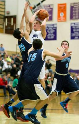 Photos by Don Beeler Forward Pat Clifford looks to shoot over two Suffern defenders.