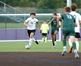Jayden Scamarone (#14) scored off a scramble to wrap up the Crusaders opening Day victory.