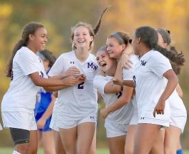 Kayla Bauer hugs Gabrielle Mpasiakos as the Crusaders celebrate her last-second game-tying goal.