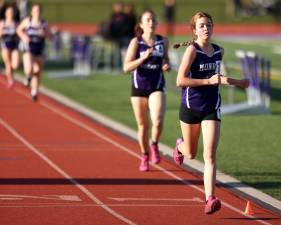 Lily Benza crosses the finish line of the 1,500-meter run.