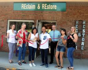 On Wednesday, August 15, members of the Warwick Valley Chamber of Commerce joined owner Cindy Tappan (center), her husband, Enrique, and business associates, to celebrate the first year anniversary of Reclaim and Restore furniture store in Merchant Square.