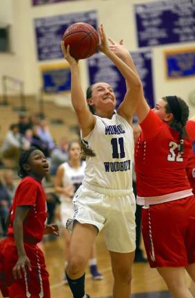 Senior Caroline Helbeck (#11) scores two of her seven points on the night.