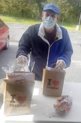 Steven Reich of Harriman picks up “Chicken Soup &amp; Challah for the Quarantined Soul” packages for himself and his grandchildren. Reich helped sponsor some of the Shabbat packages in honor of his birthday he celebrated on Shabbat.