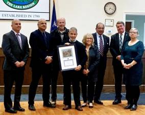 The Town of Monroe honored longtime volunteer John Battaglia at the Oct. 18th Town Board Meeting for his 21 years of dedicated service to the Monroe Joint Parks &amp; Recreation Commission. John spent six of those years as Board Chair. He is pictured here with his wife Carol and members of the Town Board and Village Mayor Neil Dwyer. “We gratefully acknowledge John’s commitment to making an impact in the Town of Monroe,” the board said. Provided photo.