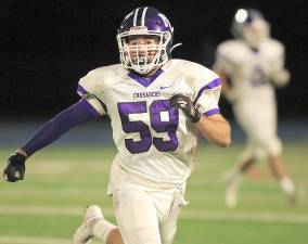 Linebacker Michael Rowe looks to stop a Patriot ball carrier. Photos by William Dimmit.