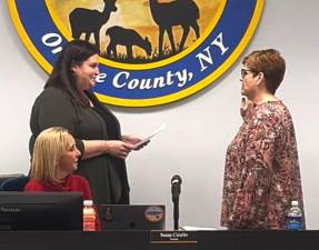 Kathleen Mottola (right) is sworn in by Village Clerk Jessica McCelennan as newly appointed Deputy Mayor Susan Ciriello looks on.