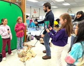 Central Valley Elementary students hold mock interviews in front of a green screen, with Matthew Krill.