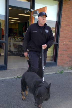 Sgt. Dave Campbell of the Orange County Sheriff's Department and Scout, an explosive detector K-9, leave Central Valley Elementary at the conclusion of an evacation drill.