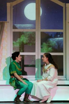 Photo by Bob Curtis Peter Pan (Anya Quinn) invites Wendy (Katharine Edel) to fly with him to Neverland to during a recent dress rehearsal for Souza&#x2019;s Peter Pan, opening this weekend. &#x2013;