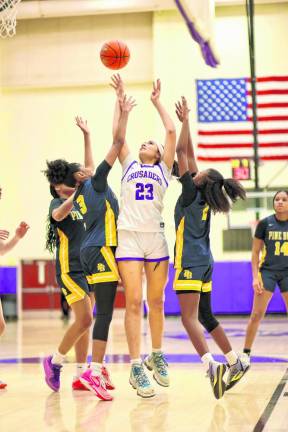 Isabela Mejia #23, battles with Bushmen defenders for a rebound.