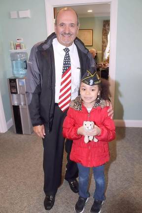 Veteran Joe Leonardi poses with Mena Hunter, age 7, who had thanked him for his service – he allowed her to wear his cap till the end of the day’s events.