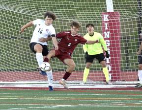 Jayden Scamarone (#14) clears the ball away from the Crusaders net.