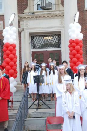 The National Anthem was performed by the High School Voice Ensemble.
