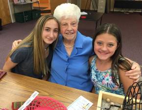 Pictured from left to right are summer volunteers Sam Briffa (left) and Madeline McCafferty (right) with Monroe Senior Center member Dottie Casalino.