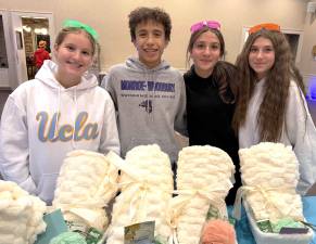 CTeen leaders Julia Olstein, Jaden Shaw, Lizzie Deskin and Gabi Patsiner, all of Monroe, direct a project of care packages designed for mothers of children with special needs.