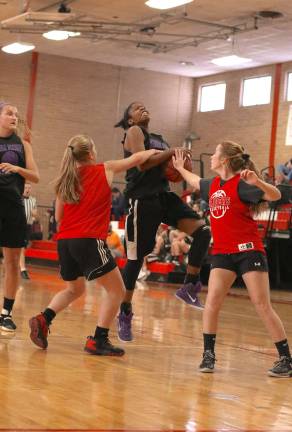 Crusader Toni Neely gets fouled on her way to the basket by a North Rockland defender.