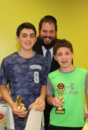 Rabbi Pesach presents Bar Mitzvah and Beyond Awards to Bar Mitzvah Gavin Reich and Joshua Caplan, both of Highland Mills (Photo provided)