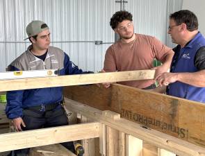 Students at Orange-Ulster BOCES in Goshen work on the modular units for the village for veterans with Corey Moore, Director of Construction Education. Photo provided.