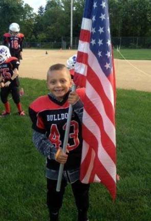 Seven-year-old Anthony Scancarello of Monroe is winning his battle with Leukemia, according to his dad, Sal. His football team recently honored Anthony by naming him captain. And this proud bulldog had the honor of carrying the flag and handling the coin toss before a recent game. He then cheered on his team!