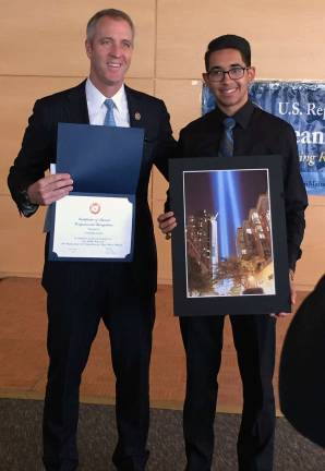 Rep. Sean Patrick Maloney shares a moment for the camera with Monroe-Woodbury student artist Brandon Colon, whose work "Seasons" earned honorable mention at Maloney's Congressional Art show.