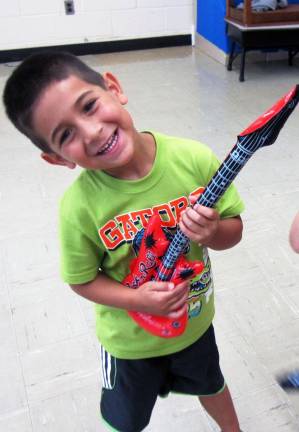Eitan Einav, 4, of Highland Mills, gets ready to jam on the Music Mitzvah Video.