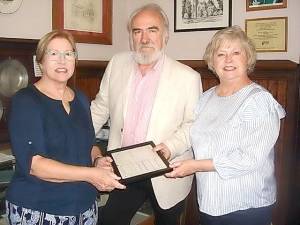 Tricentennial Ball Committee chairs Elizabeth Long, John Redman, and Linda Clark look over historical church documents at the First Presbyterian Church in Goshen, which is celebrating its 300th anniversary in 2020, starting with the ball on Oct. 19.