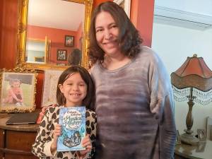 Melissa R. Mendelson with niece Olivia, who holds the Calliope Collection where one of Mendelson’s stories was published.