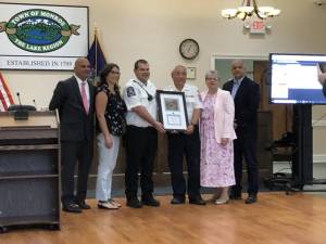 The Town of Monroe board gave Monroe Volunteer Ambulance Company a plaque for their 75th anniversary. Holding the plaque are MoVAC members Richard Haley(left) and Wayne Chan(right).