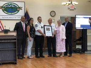 The Town of Monroe board gave Monroe Volunteer Ambulance Company a plaque for their 75th anniversary. Holding the plaque are MoVAC members Richard Haley(left) and Wayne Chan(right).