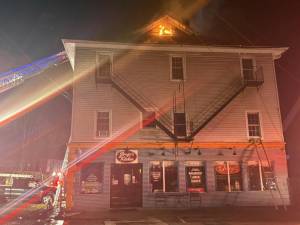 A fire burns atop the mixed use building at 34 Smith Clove Road in Central Valley Nov. 20.