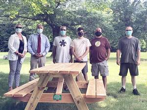 Aidan Corrado, pictured fourth from the left, built 10 picnic benches at O&amp;R Park for his Eagle Scout project. Provided photo.