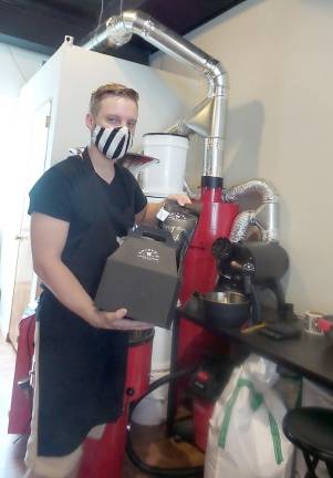 Dakota Rudolph packaging coffee for a drone delivery from Valkyrie Coffee Roasters in Chester. Photo by Frances Ruth Harris.