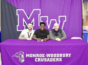 Kamal Salaudeen signs his letter with Assistant Coach Anthony Amoroso and Head Coach James Sciarra.