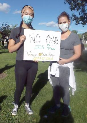 Alexis Simonetti's and Rosa Ferrara's sign: No One if Free When Others are Oppressed