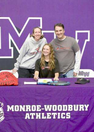Maeve Cassidy with her parents signs her letter