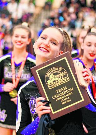 Crusader Captain Kassidy Schaffer holds the Section 9 Championship plaque.