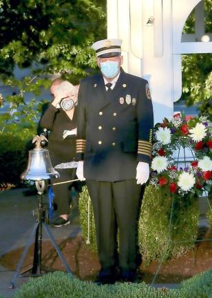 Fire Chief John Scherne tolls the bell after each of the victims names are read.
