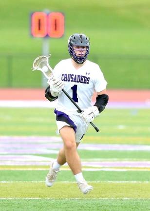 CJ Gullotta brings the ball into offensive zone for the Crusaders. Photos by William Dimmit.