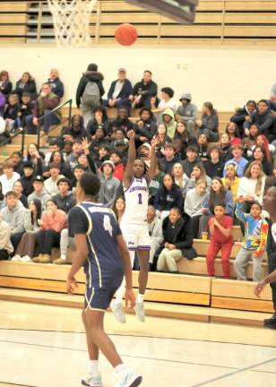 Jayden Desir, #1, hits a three-point shot in front of a packed house on Monday night.