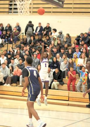 Jayden Desir, #1, hits a three-point shot in front of a packed house on Monday night.