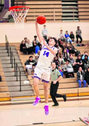 Senior TJ Mancuso, #14, drives to the basket in the third.