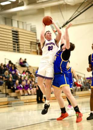 Crusader center Kyle McDermott, #23, powers his way over a Wizard defender.