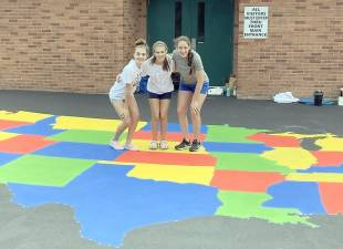 Pictured from left to right are Girl Scout Cadettes Marisa Ely, Emily Zrelak and Jillian Meyers of Troop 432 who for their Girl Scout Silver Award Project aimed to create playground enhancements and provide new options for students to exercise at Pine Tree Elementary School. Their plan incorporated several COVID-19 elements, included a variety of non-touch activities, two square game areas, as well as a large, colorful map of the United States. Provided photo.