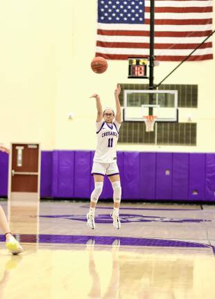 Chloe Ahorrio, #11, nails a three-point shot.