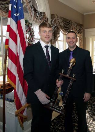 Quarterback Richard Martucci, left, receives the Offensive Player of the Year award from Head Coach Ryan Baldock.