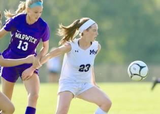 Lindsay Sundheimer (#23) fights through a Wildcat hold to maintain possession of the ball. Photos by William Dimmit.