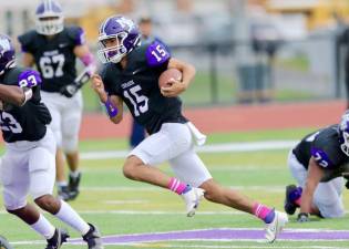 Quarterback David Fennessy, #15, got the Crusaders offense going when he scored on a 58-yard run in the first quarter.