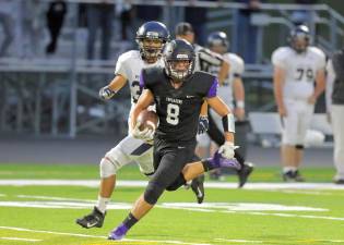 Vincent Quintana (#8) heads up field with a pass in the first quarter.