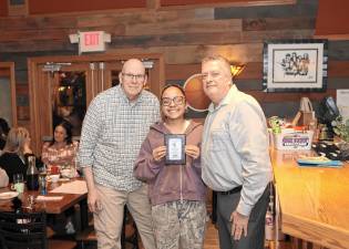 Head Coach Dave Powers and assistant coach William Earl present the MVP Award to Madison Fileen.