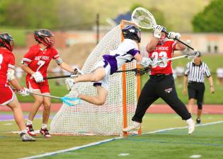 Luke Damiani dives in front of the Raiders goal and gets off a shot, the sophomore scored five goals in the game.